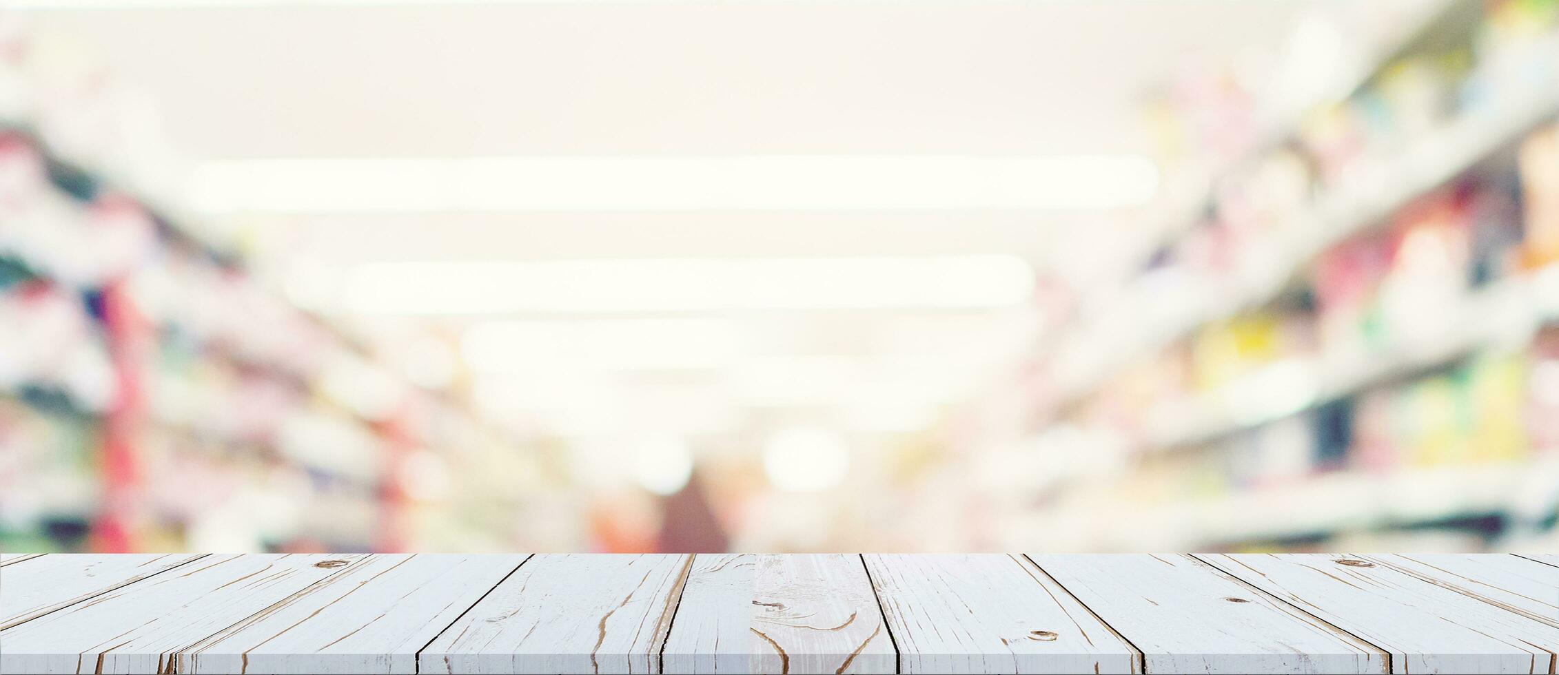 Empty wood table and blurred light table in shopping mall with bokeh background. product display template. photo