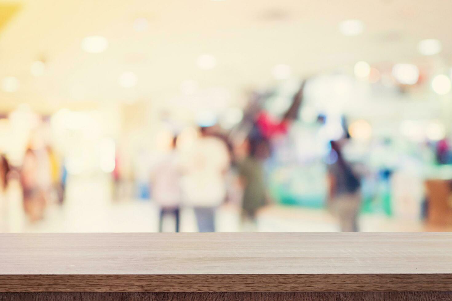Empty wooden table for product display or montage and blurred shopping mall background. photo