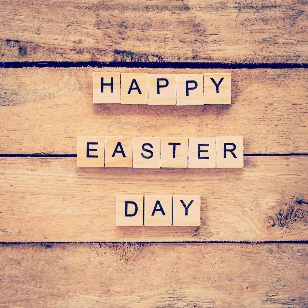 Wooden text of Happy Easter Day on wood background photo