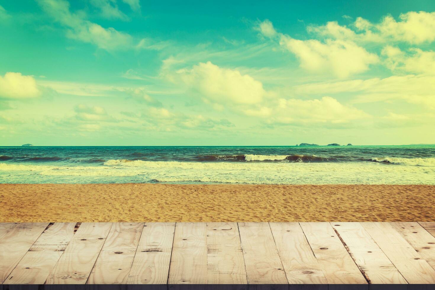 Empty wood table for product display and montage on beach with vintage toned. photo