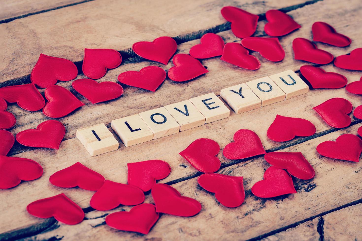 Close up wooden text for I LOVE YOU and Red heart on wood background. photo