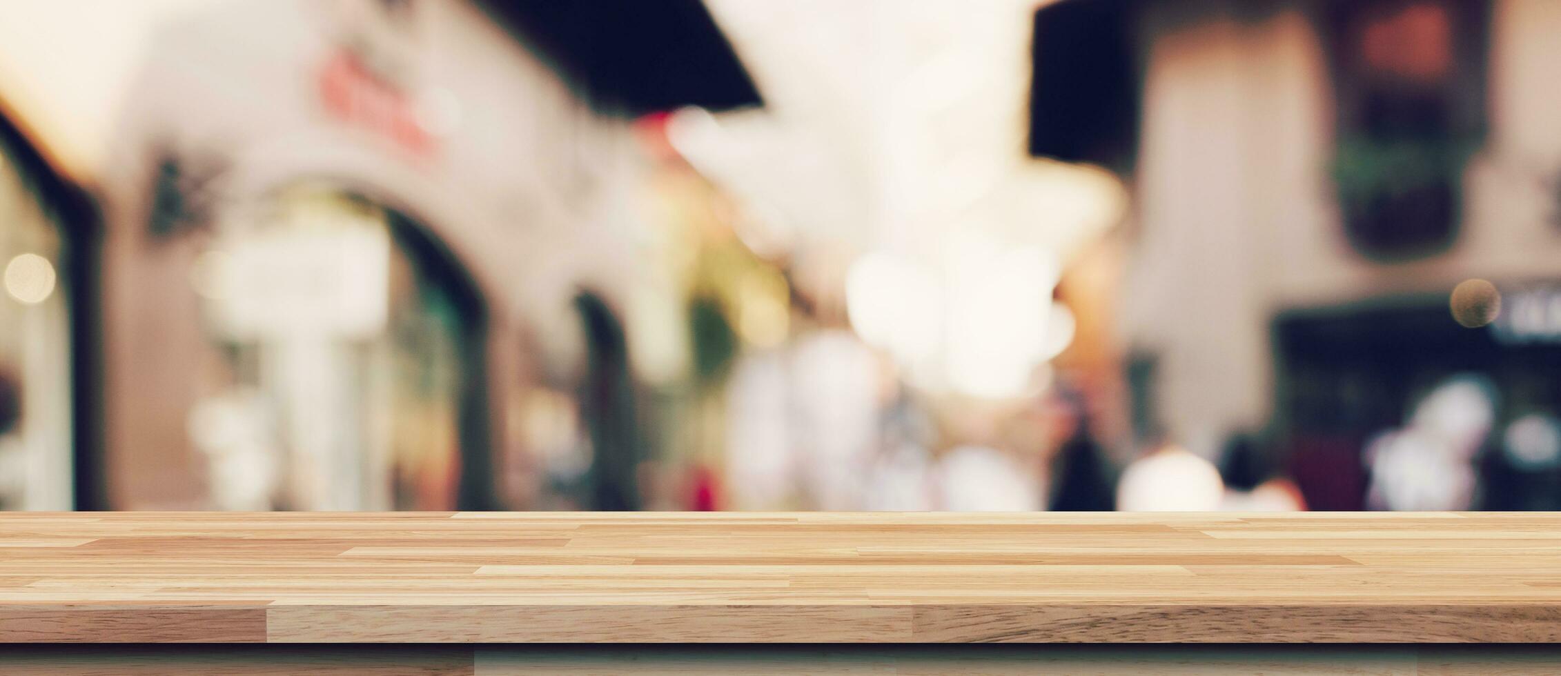 Empty wood table and blurred light table in shopping mall with bokeh background. product display template. photo