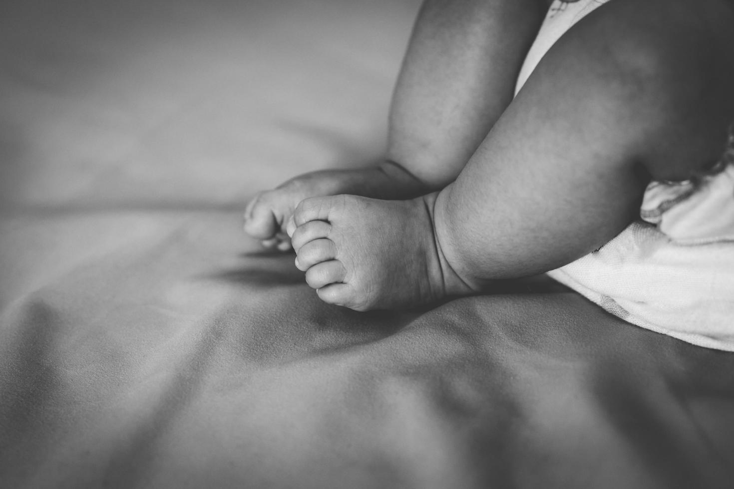 Close up newborn baby leg photo