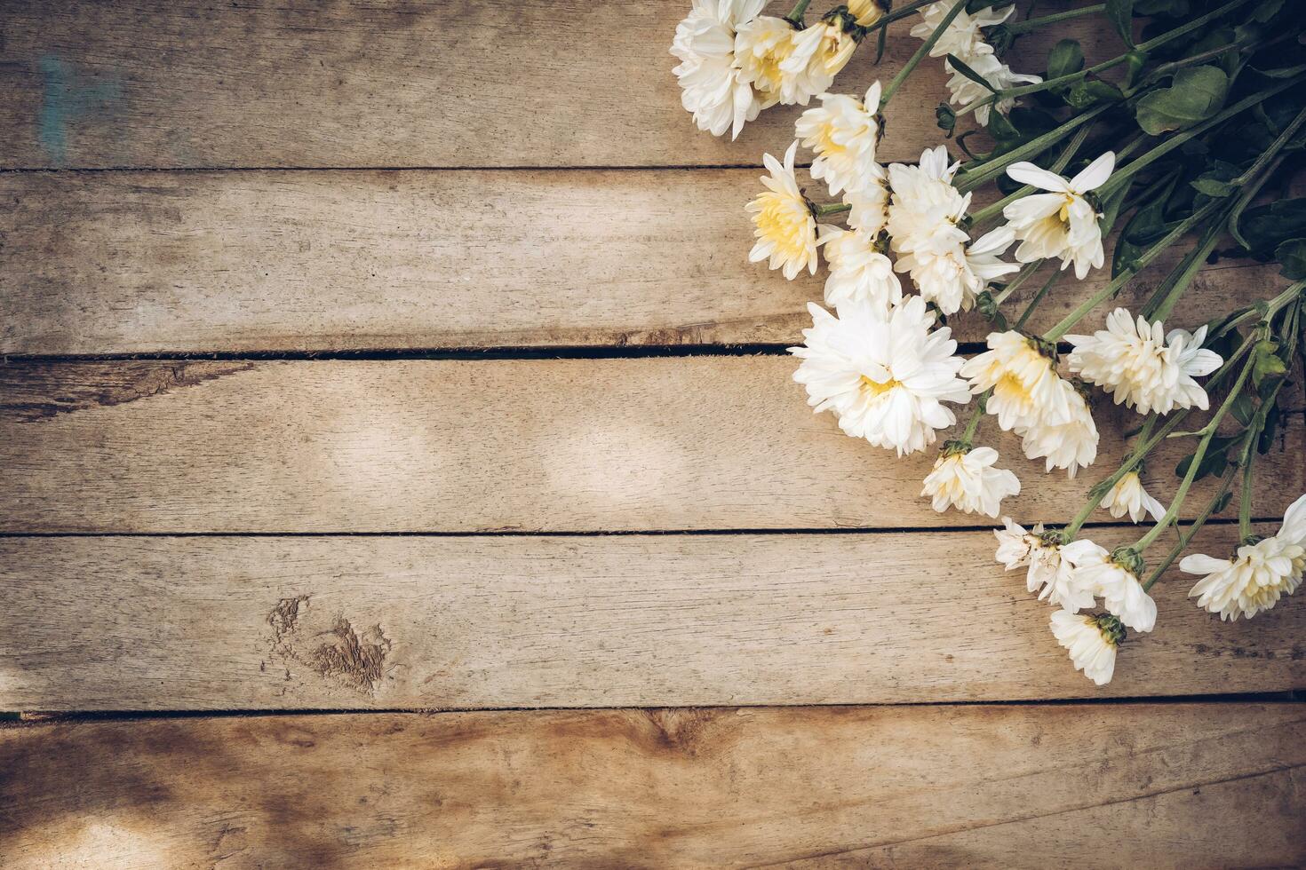Flowers on old grunge wooden table texture and background with copy space. photo