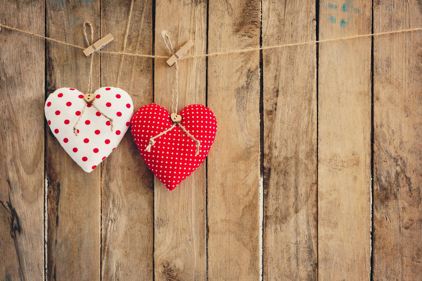 Heart  hanging on wood background with copy space. photo