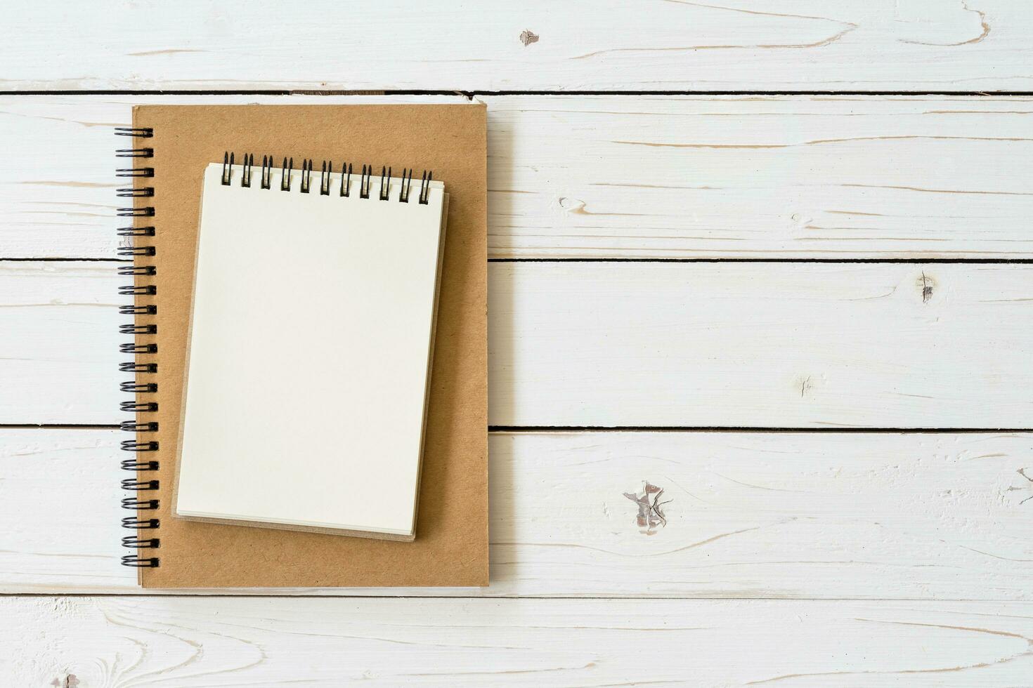 Open notebook with blank pages and on wood table photo