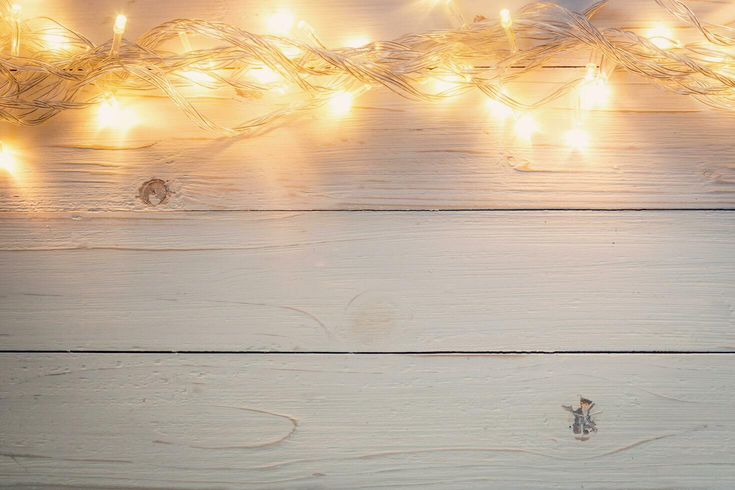 christmas background and lights garland on wood background with space. photo