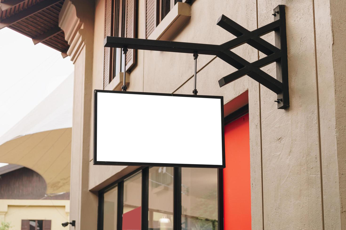 Empty signage and blank mock up hanging on street with copy space photo