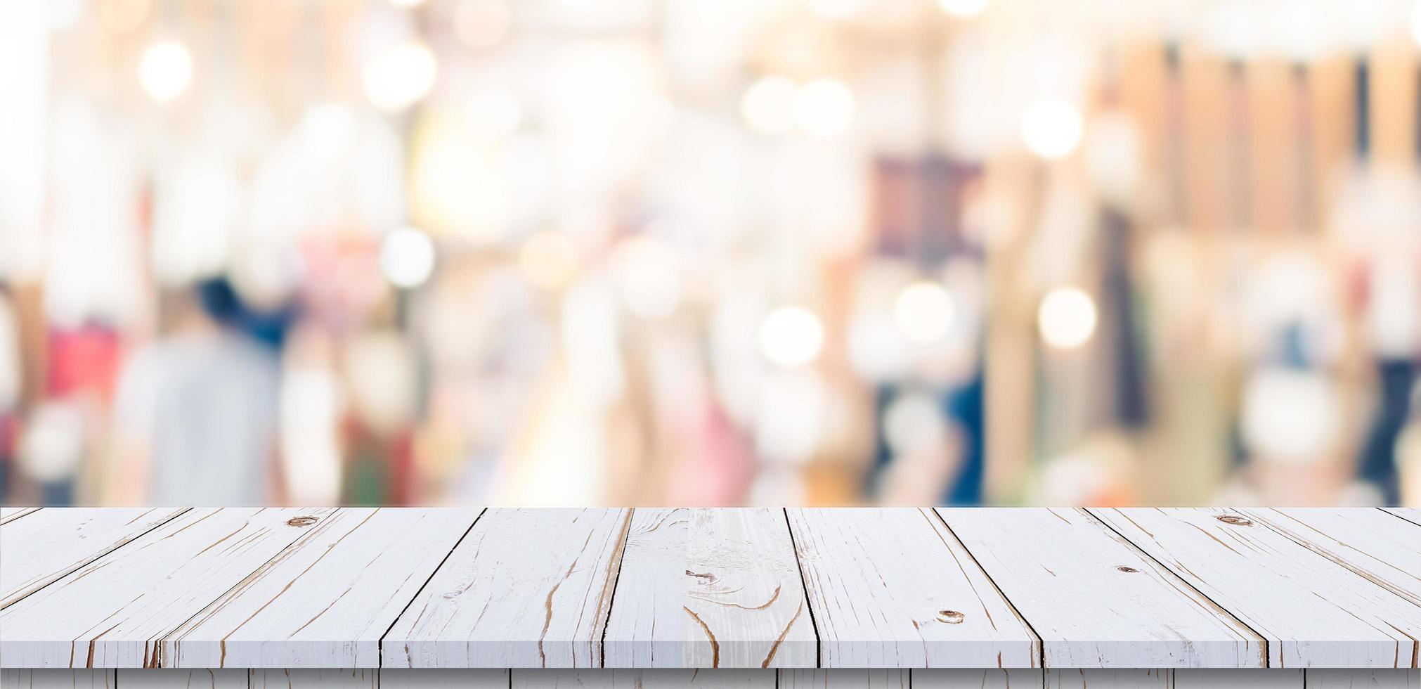 Empty wood table and blurred light table in shopping mall with bokeh background. product display template. photo