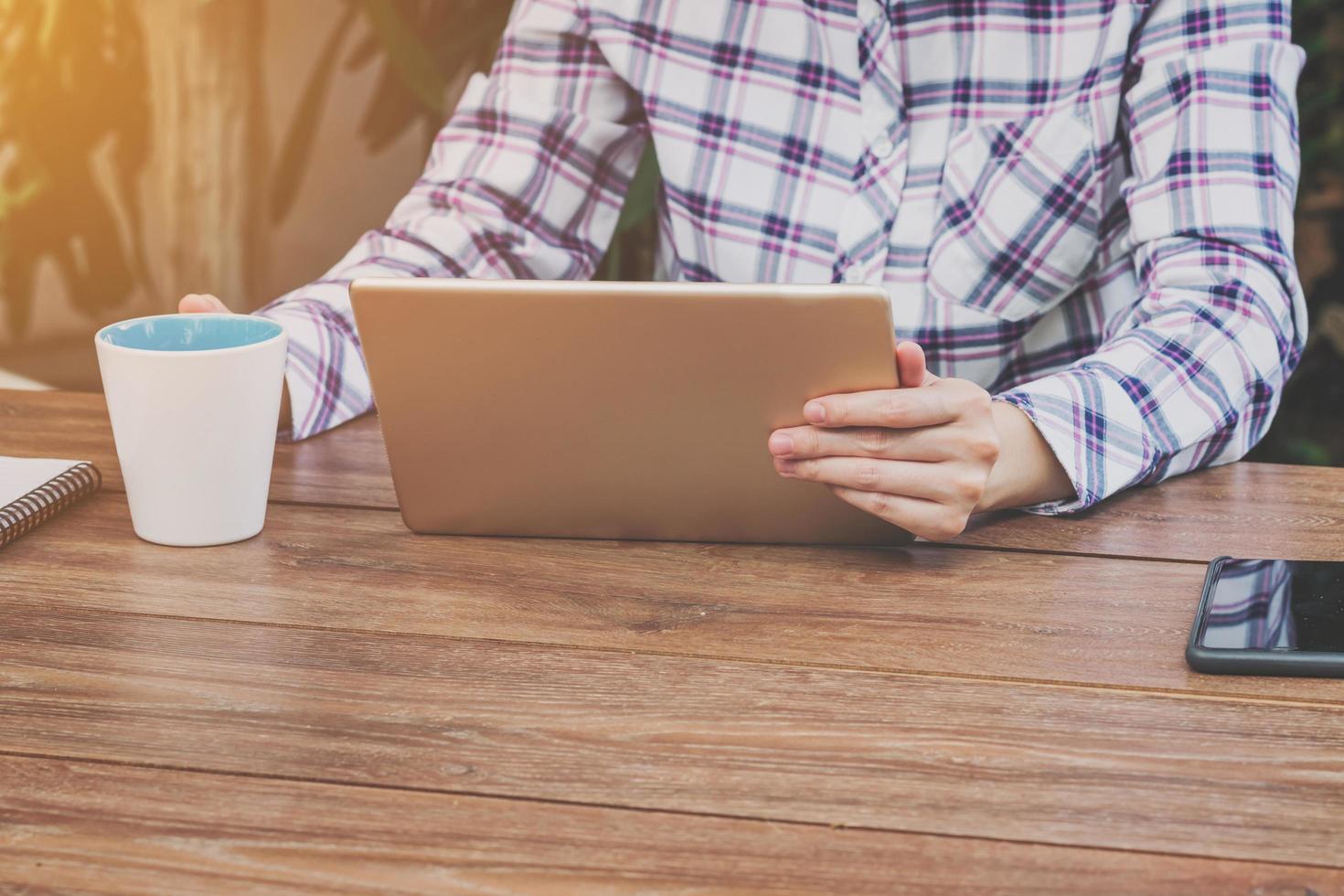 Asia woman holding tablet on table in coffee shop photo