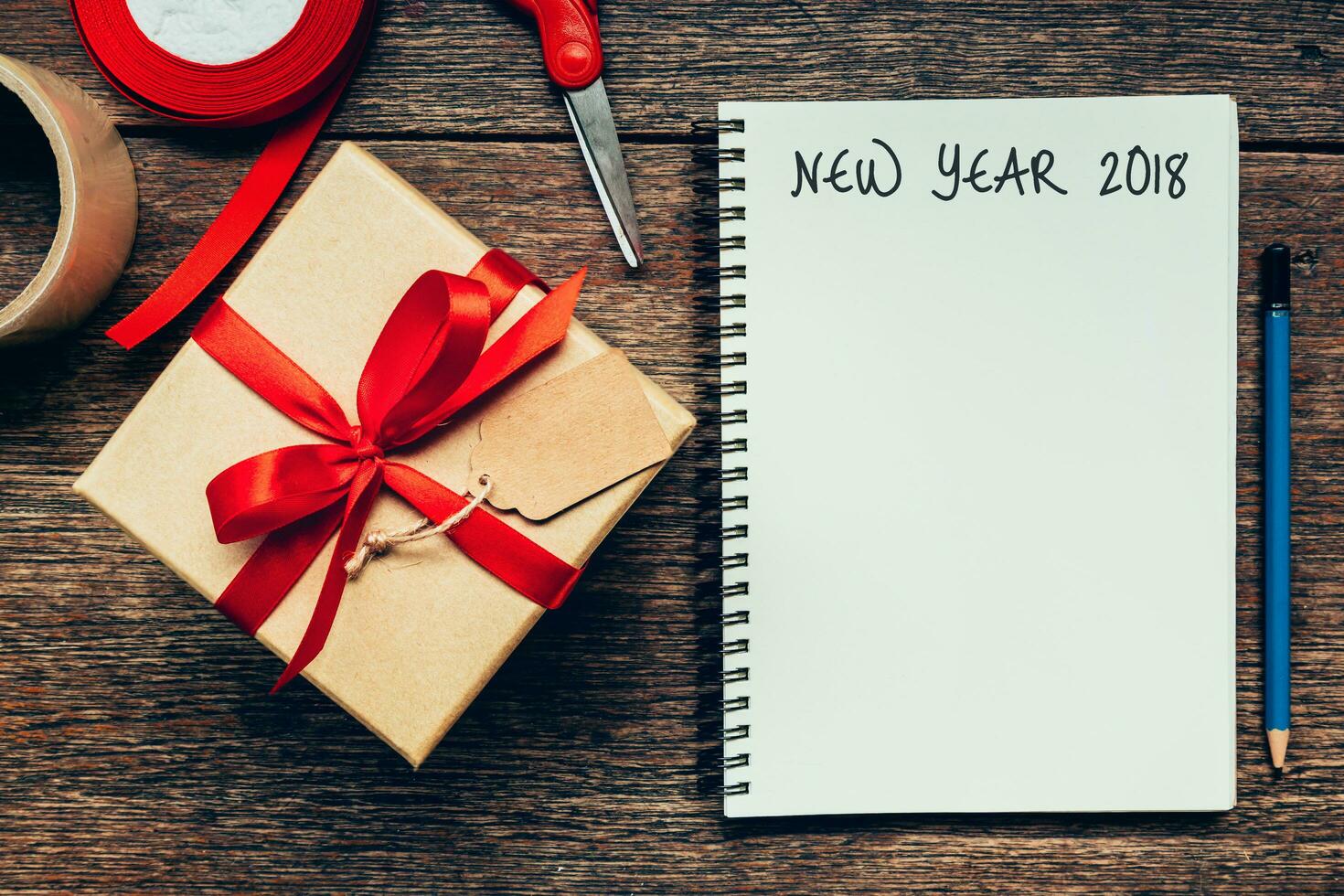 New Year 2018 on blank paper note book on wood table background. photo