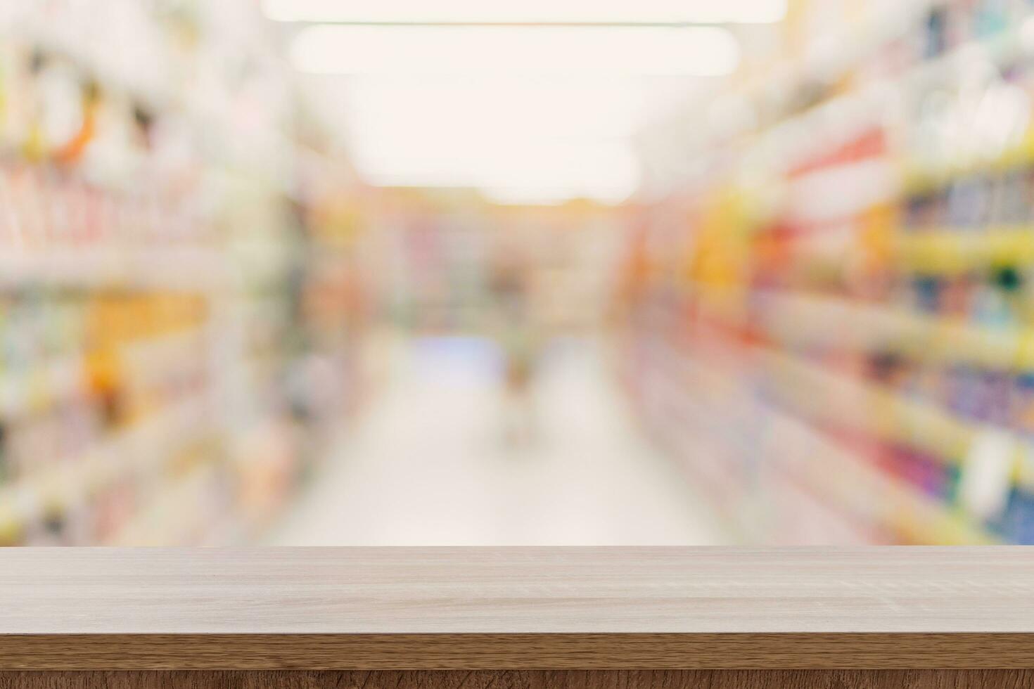 Empty wooden table top with blurred modern shopping mall background for product display and montage. photo