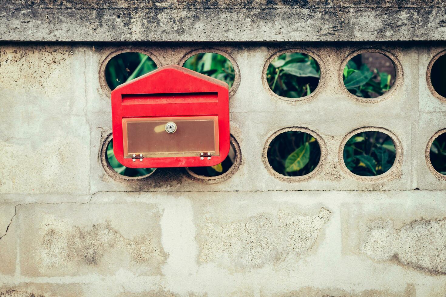 Close up red mail box on cement wall photo