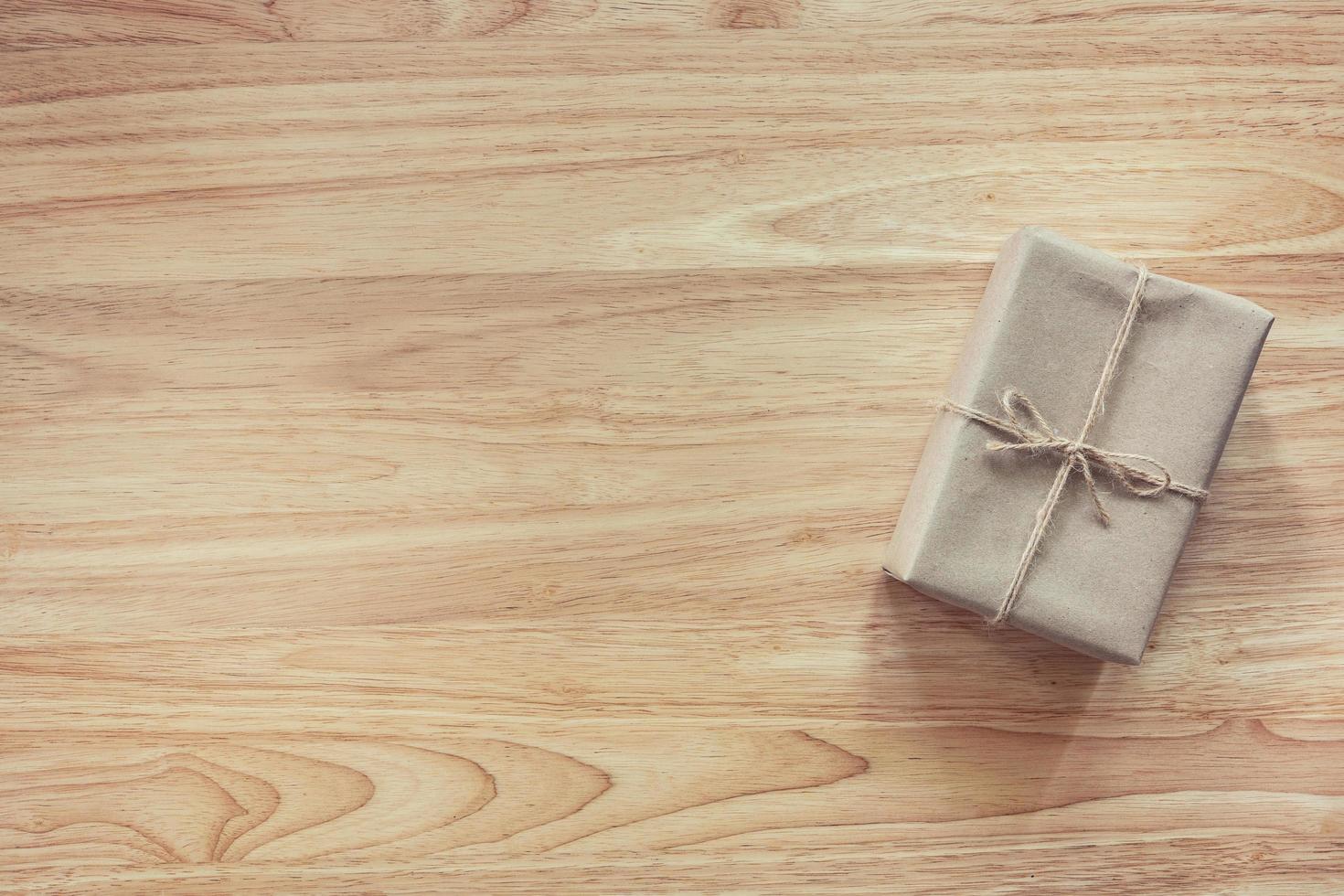 Brown gift box on wooden table background with copy space photo