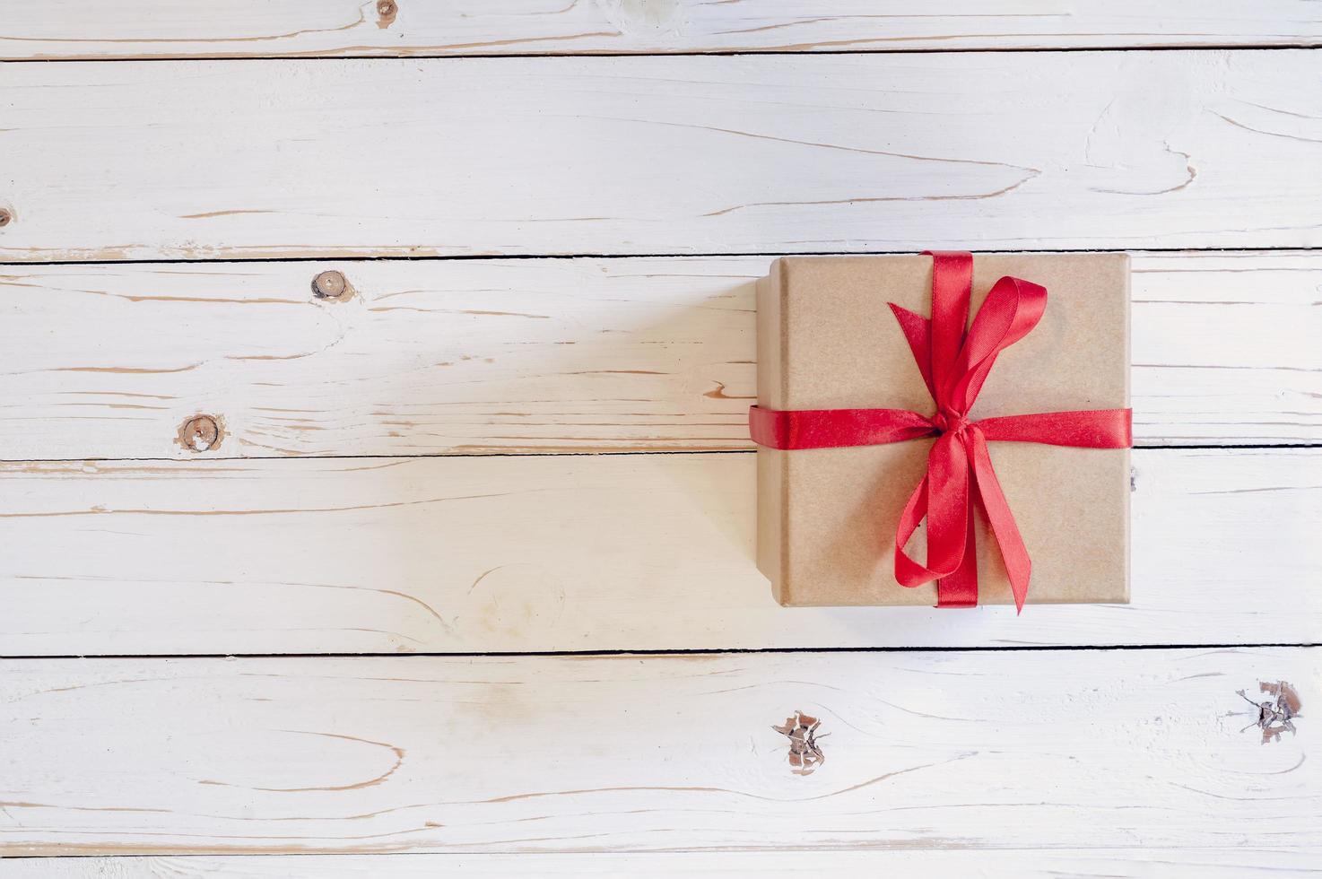 Top view brown gift box on white wood table background with copy space. photo