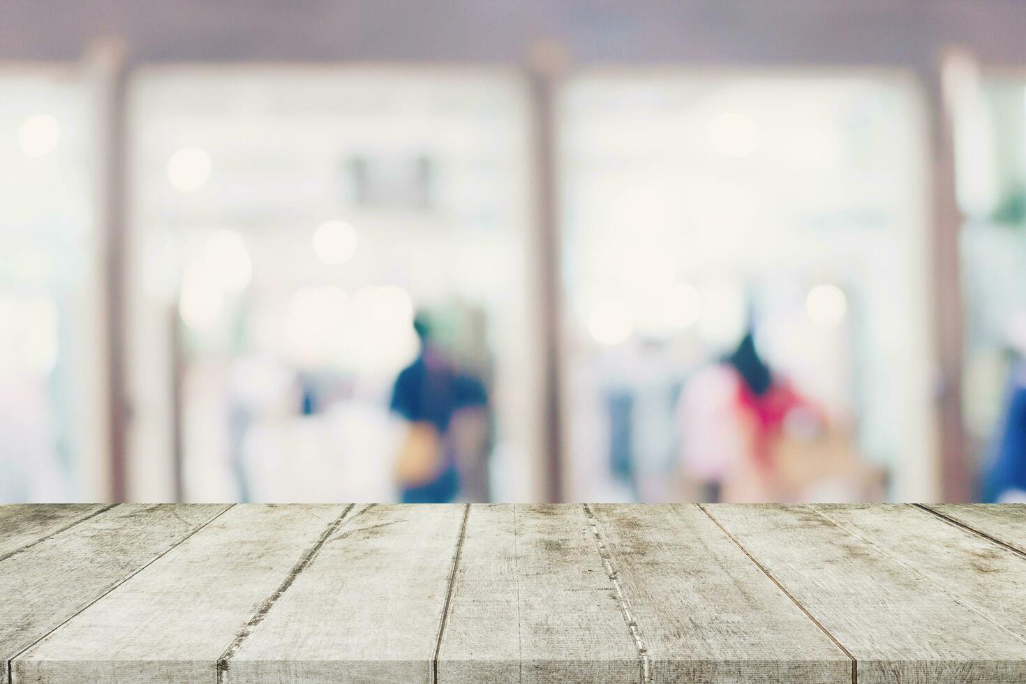 Empty wooden table and Blurred background - Store of shopping mall blur background bokeh with display montage for product. photo