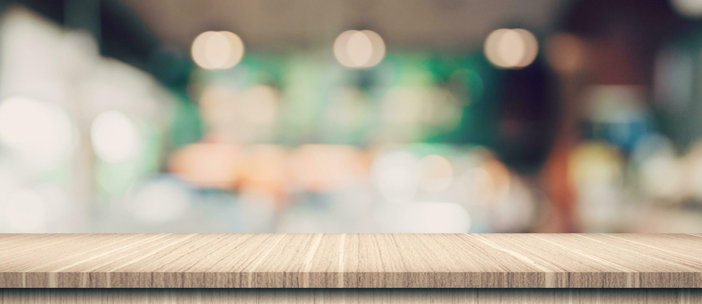 Empty wood table and blurred light table in coffee shop and cafe with bokeh background. product display template. photo