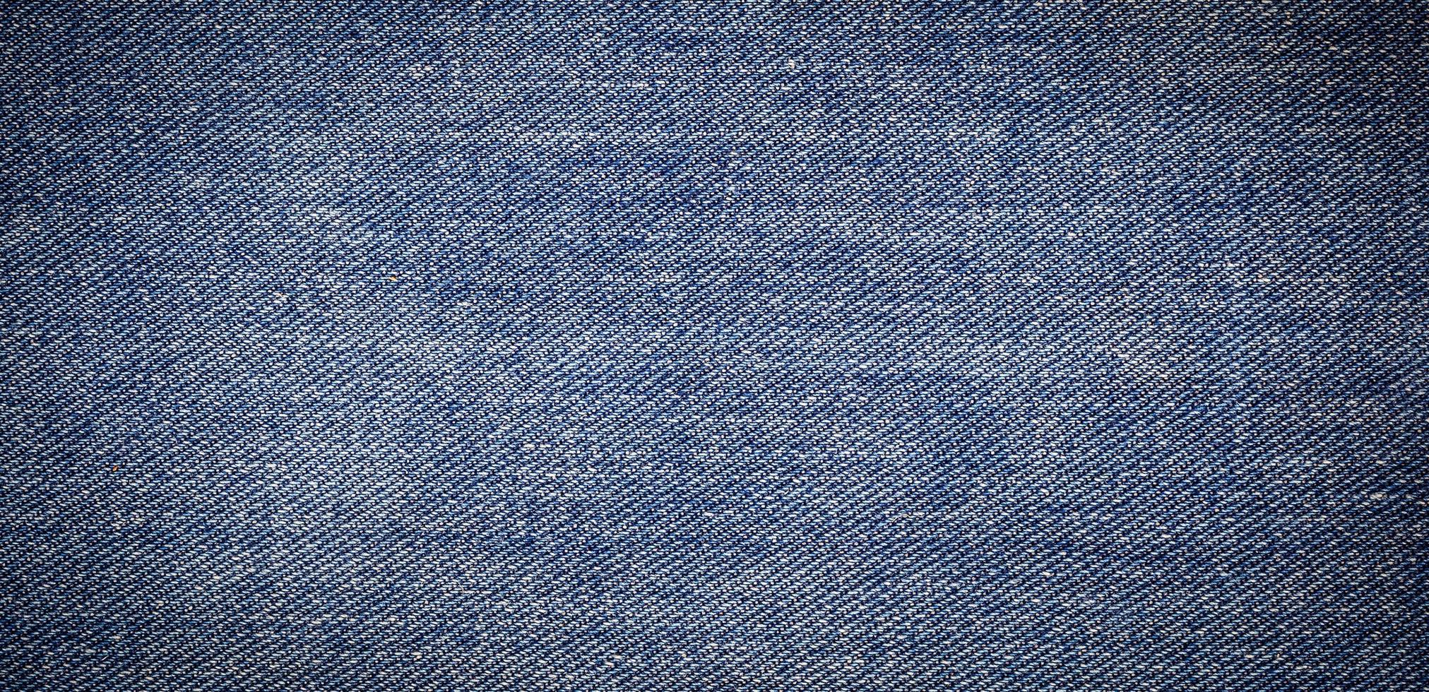 panorama of old blue jeans background and texture photo