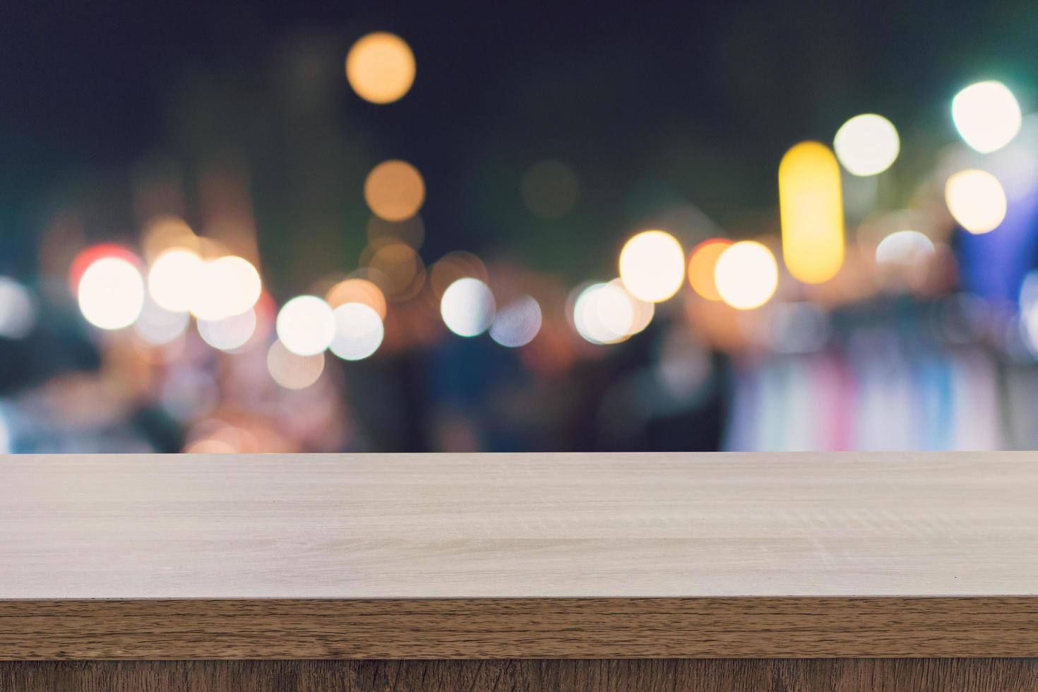 Empty wood table top for product display montage and blurred bokeh night. photo