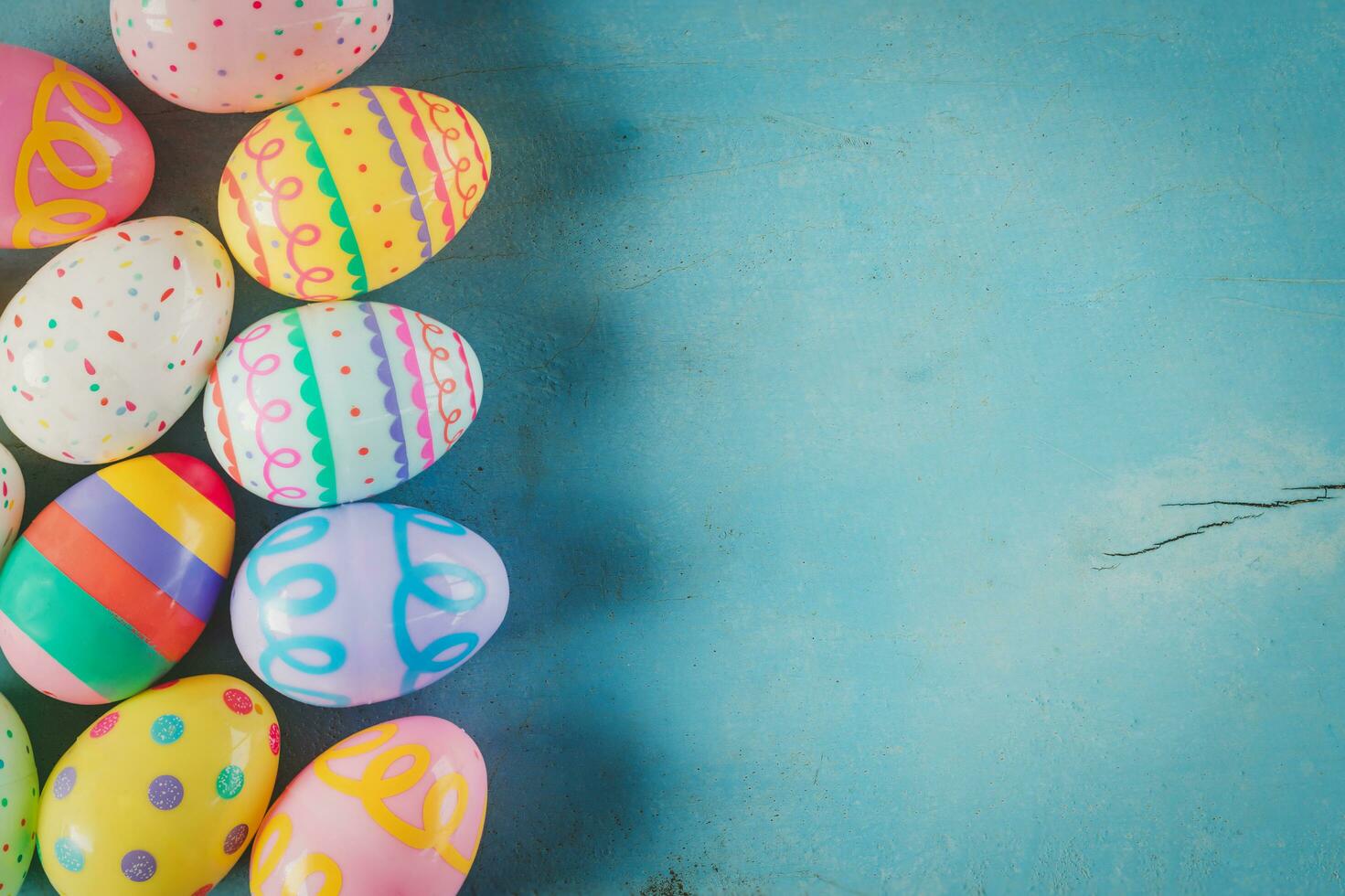 Colorful easter egg on blue pastel color wood background with space. photo