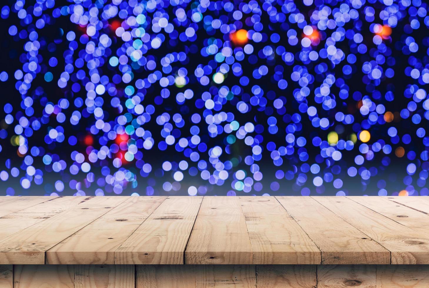 Abstract circular boken night background and empty wooden table display montage for product with copy space. photo
