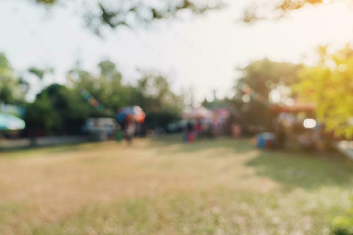 Abstract blur people and sunlight at festival in the city park garden with bokeh background. photo