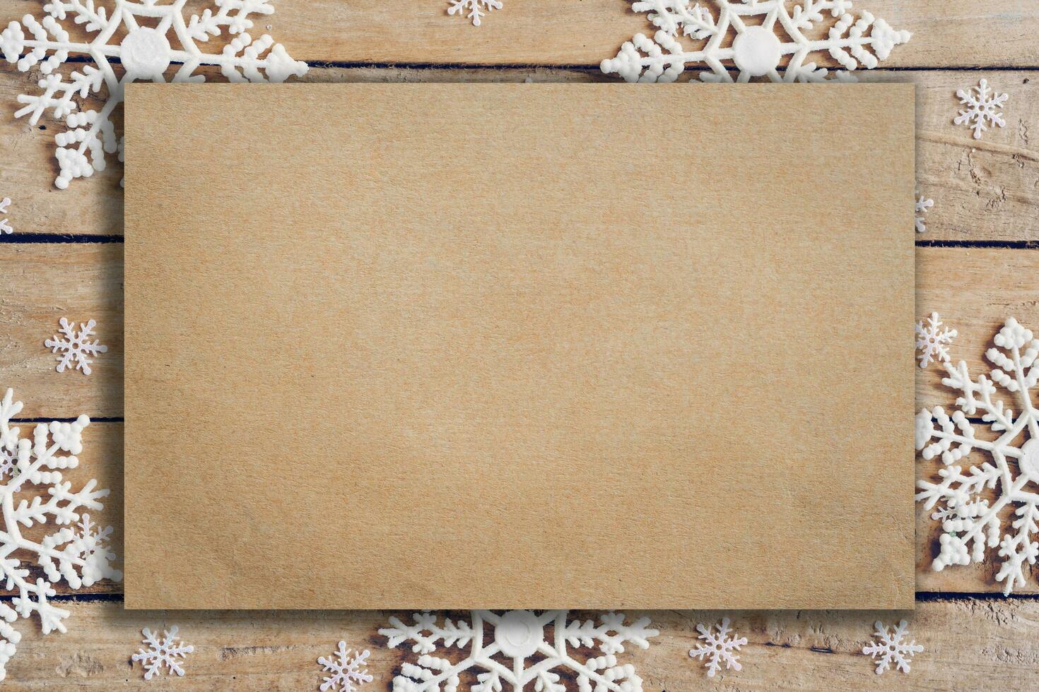 Wooden brown christmas background with snowflakes and old brown paper with space. photo