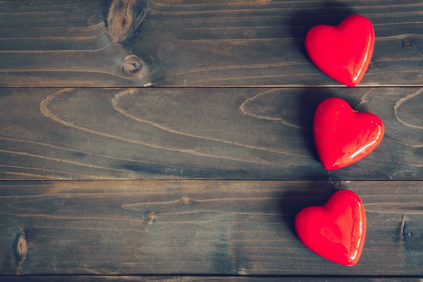 red heart on wood table background with copy space photo