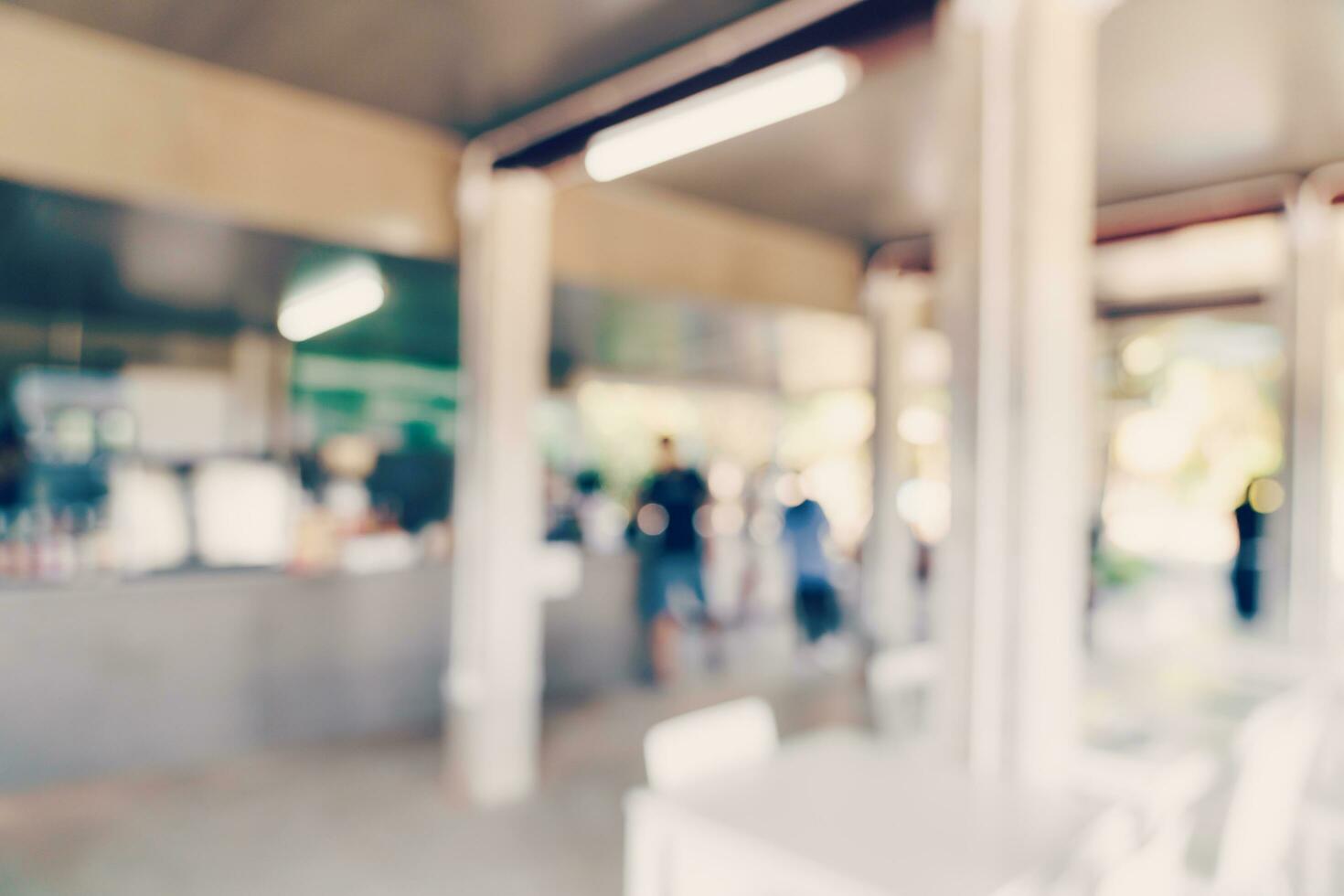 Blur coffee shop or cafe restaurant with bokeh light photo