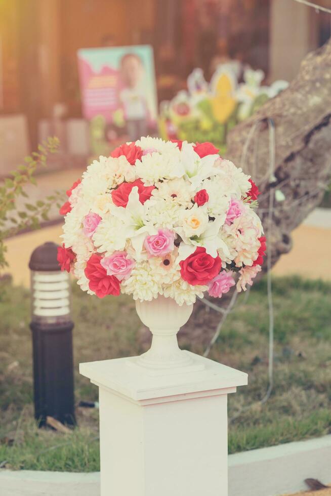 Colorful decoration artificial flower with vintage toned. photo