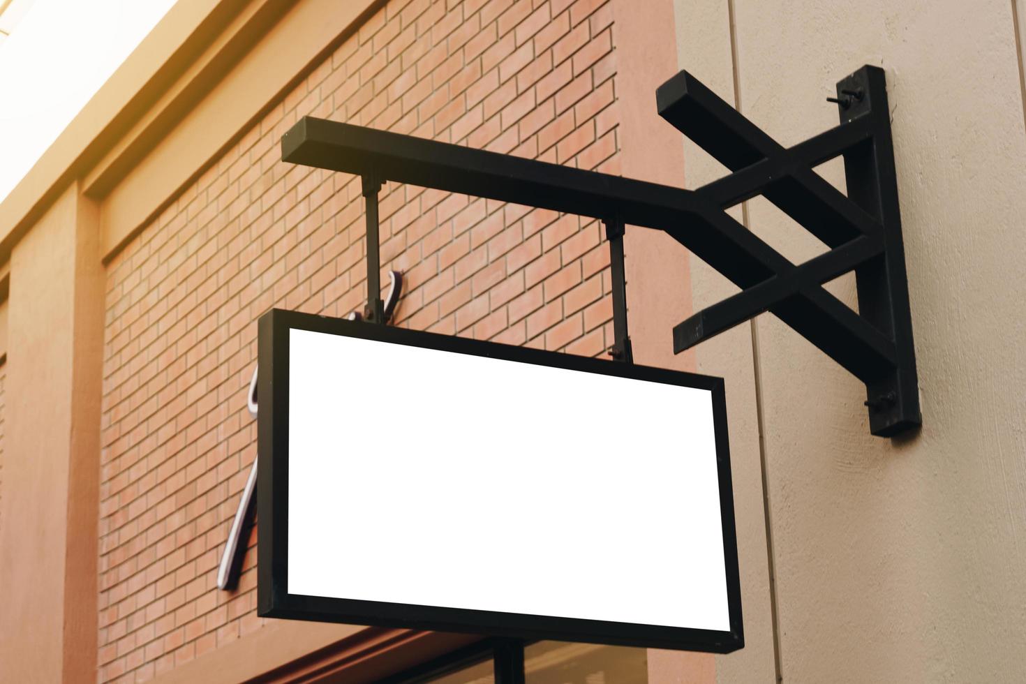 Empty signage and blank mock up hanging on street with copy space photo