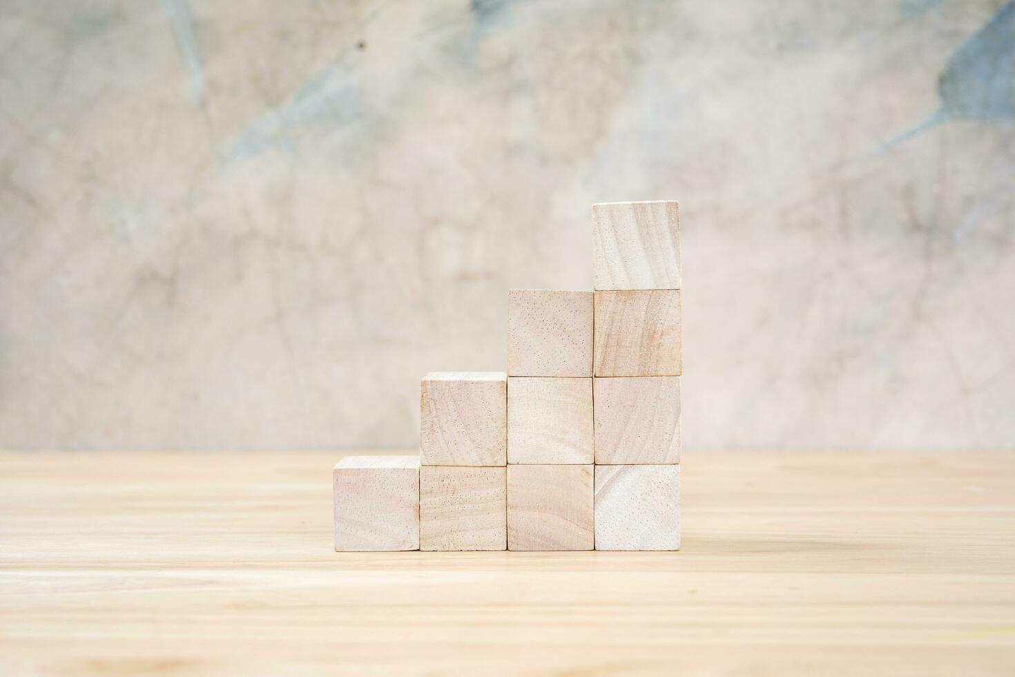Wooden toy cubes on wooden table ang grey background photo
