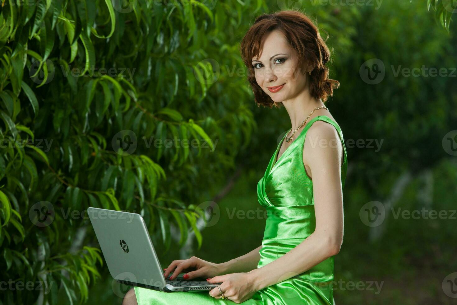 Beautiful woman or business woman talking on a cell phone outside. Outdoor portrait of a beautiful happy businesswoman talking on cell phone. photo