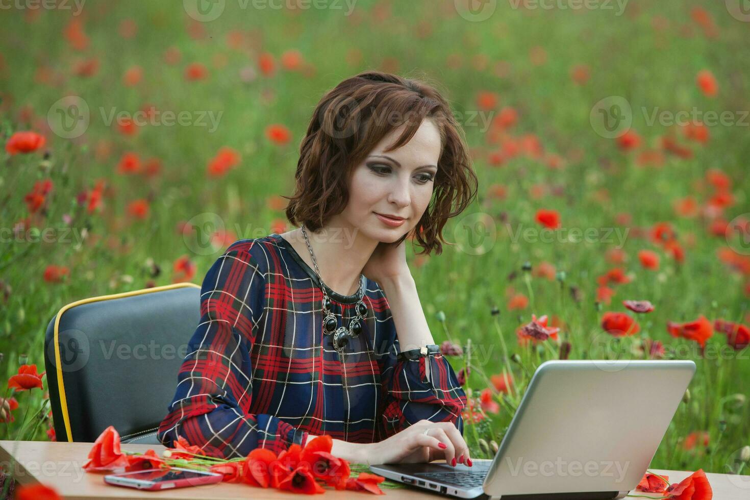 Beautiful woman or business woman talking on a cell phone outside. Outdoor portrait of a beautiful happy businesswoman talking on cell phone. photo