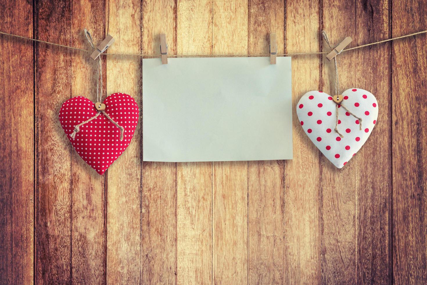 Heart and paper hanging on wood Background and Texture, Vintage toned. photo