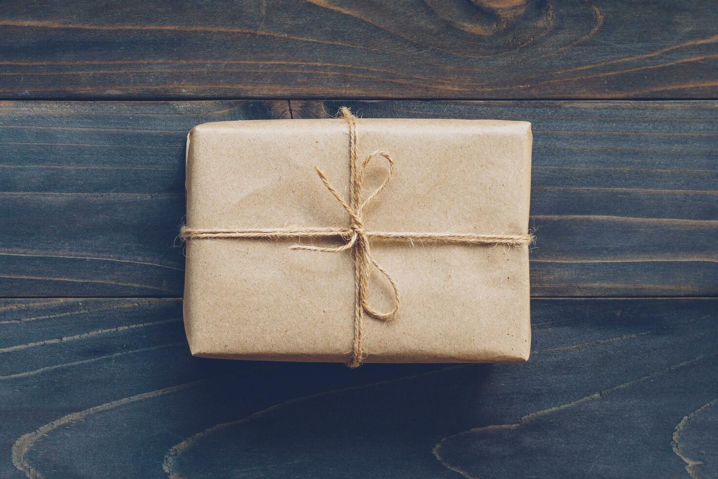 String or twine tied in a bow on kraft paper gift box no wooden table texture and background. photo