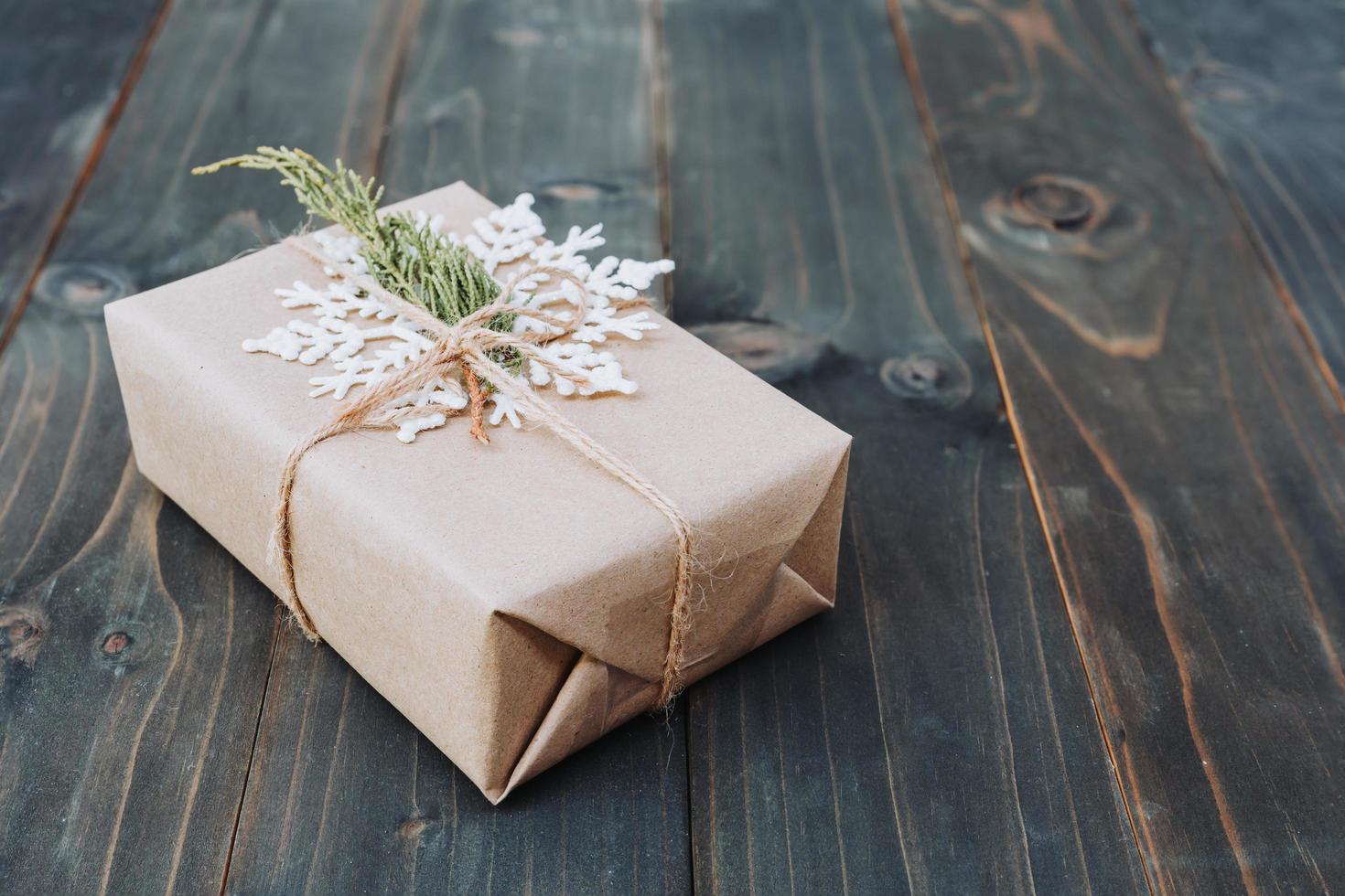 String or twine tied in a bow on kraft paper. Beown gift box on wood with space. photo