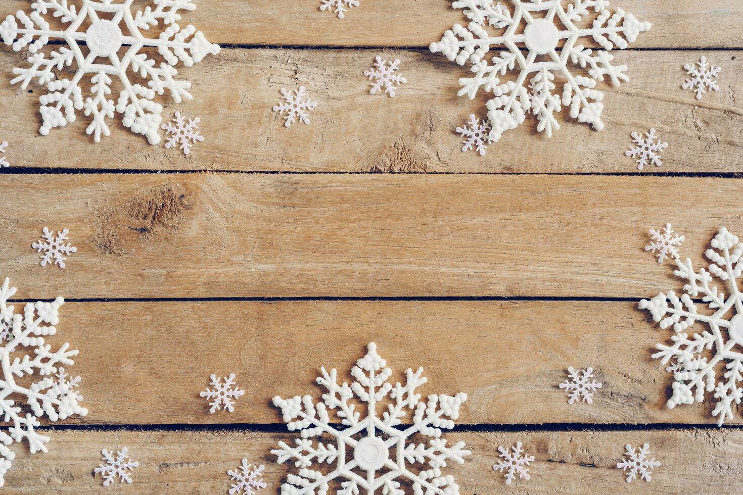 Wooden brown christmas background with snowflakes and christmas decoration. photo