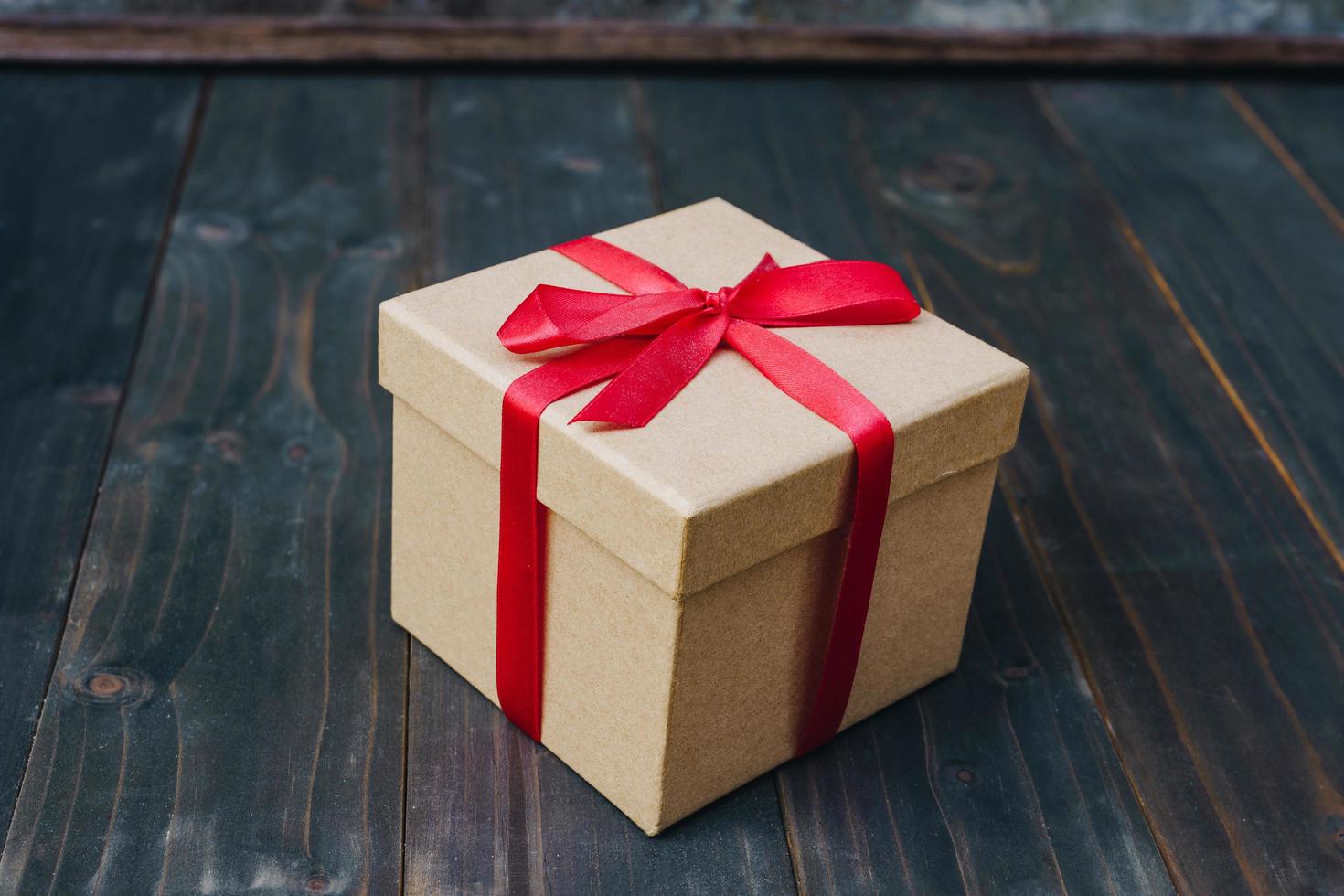 brown gift box on wooden table background with copy space. photo