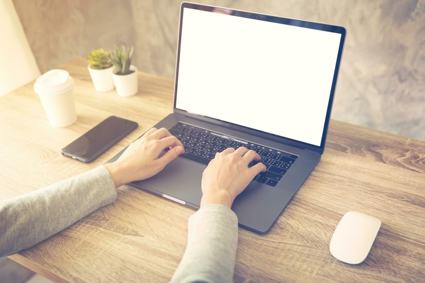 Business woman using laptop computer do online activity on wood table at home office. photo