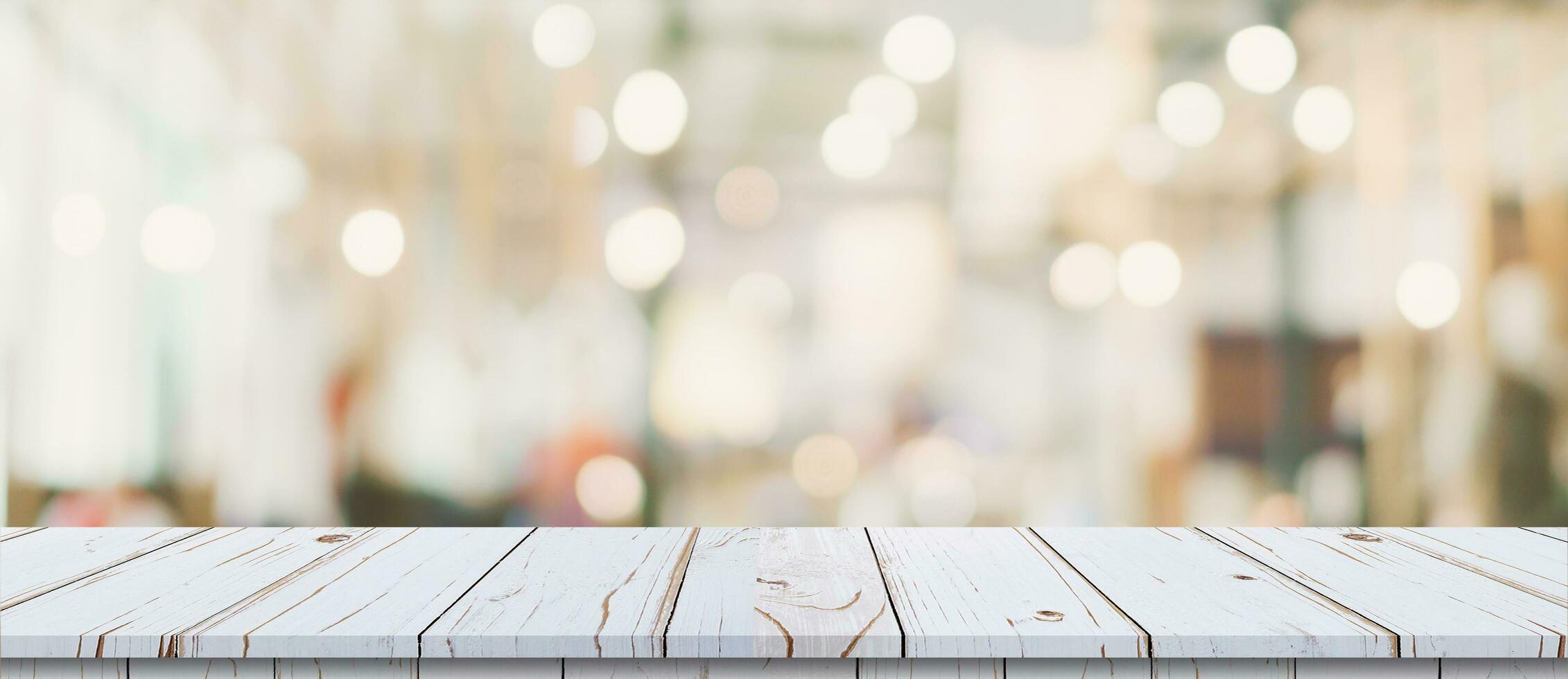 Empty wood table and blurred light table in shopping mall with bokeh background. product display template. photo