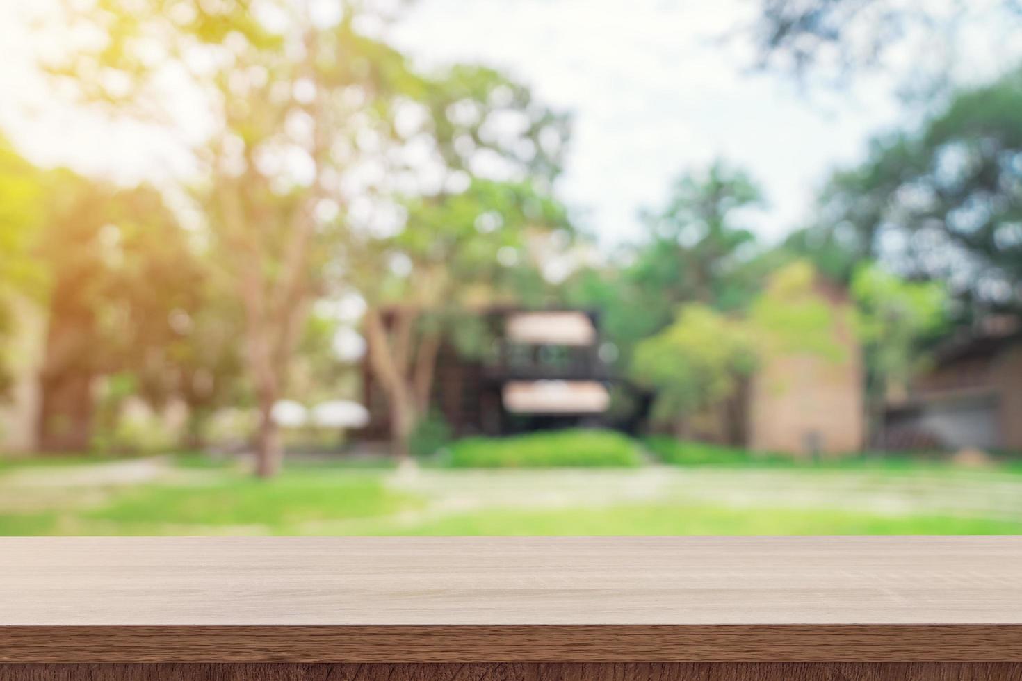 Empty wooden table top and green bokeh display montage for product with space. photo