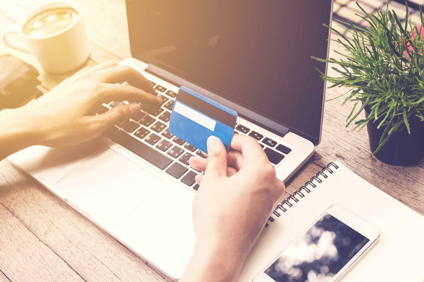Man holding credit card and using laptop. Online payment. photo