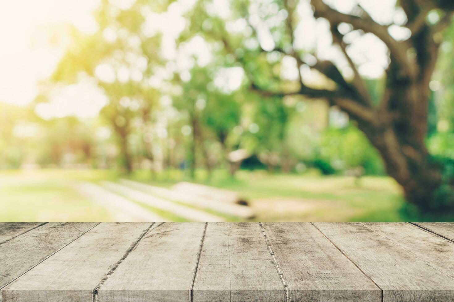 Empty wooden table top and green bokeh display montage for product with space. photo