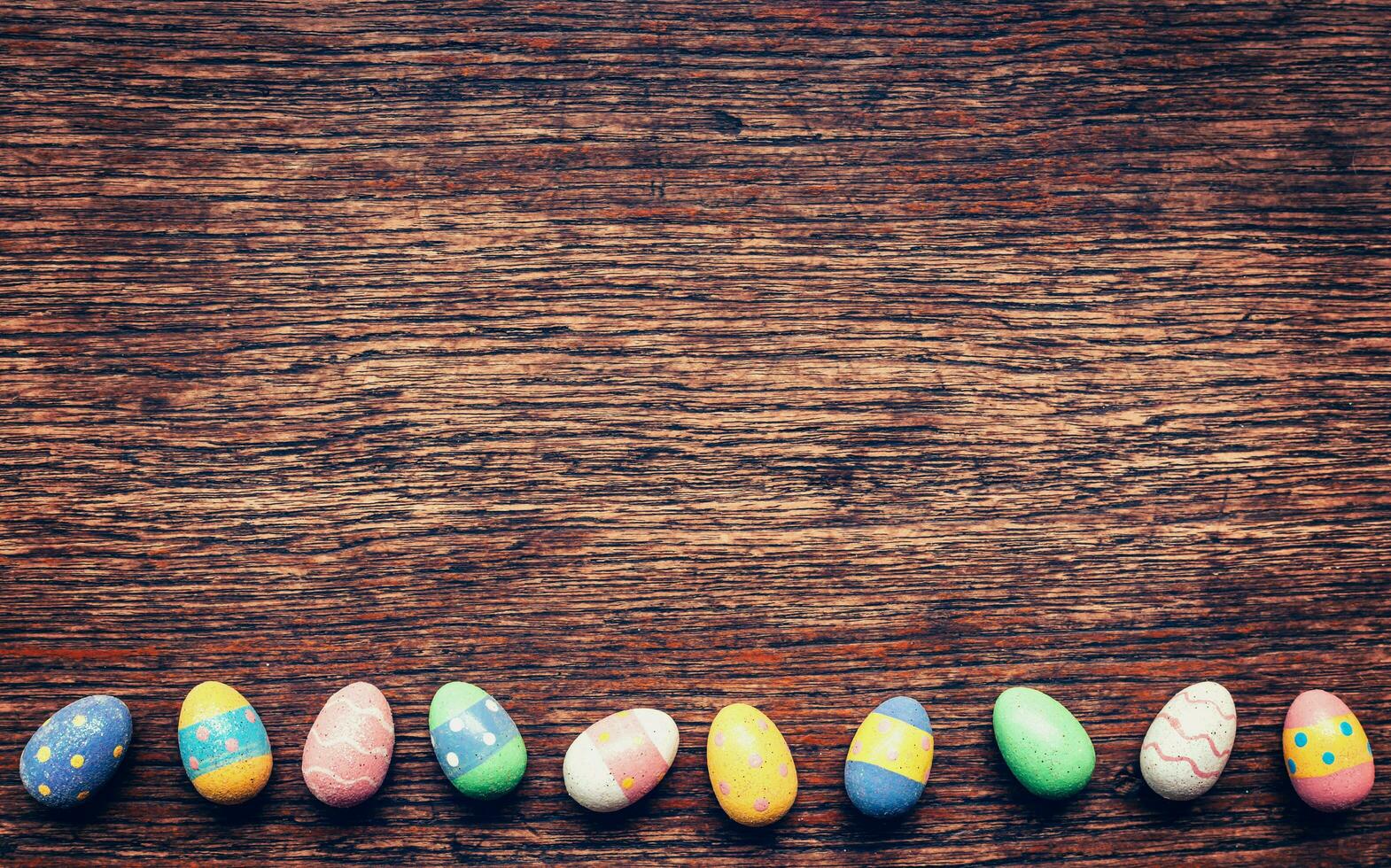Colorful easter egg on wood background with space. Vintage toned. photo