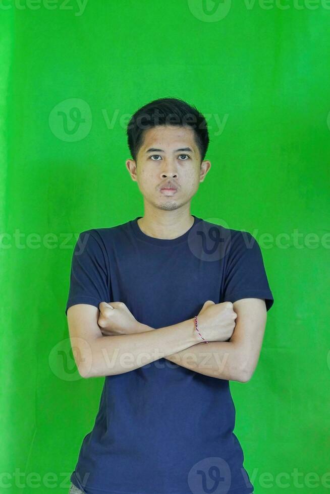 expressive casual Balinese Asian guy model for advertising with green screen studio background photo