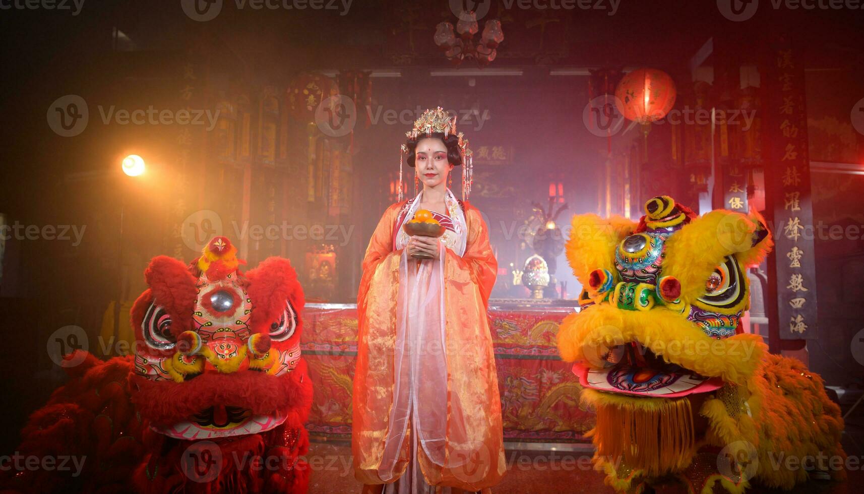 Chinese woman with yellow and red lions It is considered to enhance the prosperity for oneself on the occasion of the Chinese New Year festival every year photo