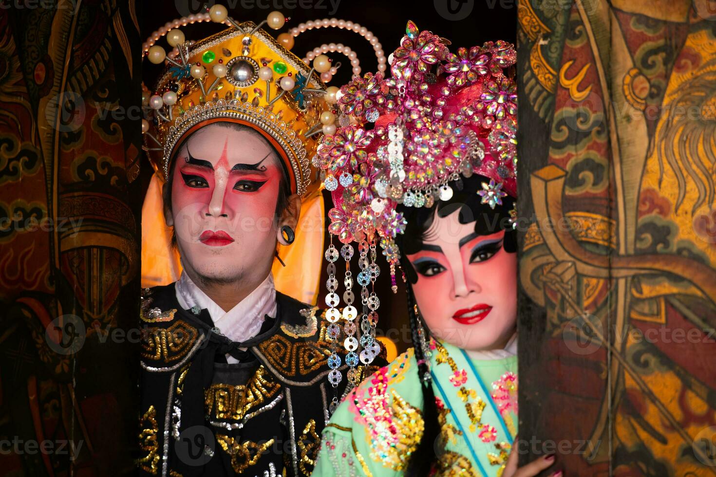 Portrait of male and female opera performers at the entrance to a sacred shrine or temple, praying for blessings on the occasion of the annual Chinese New Year. photo