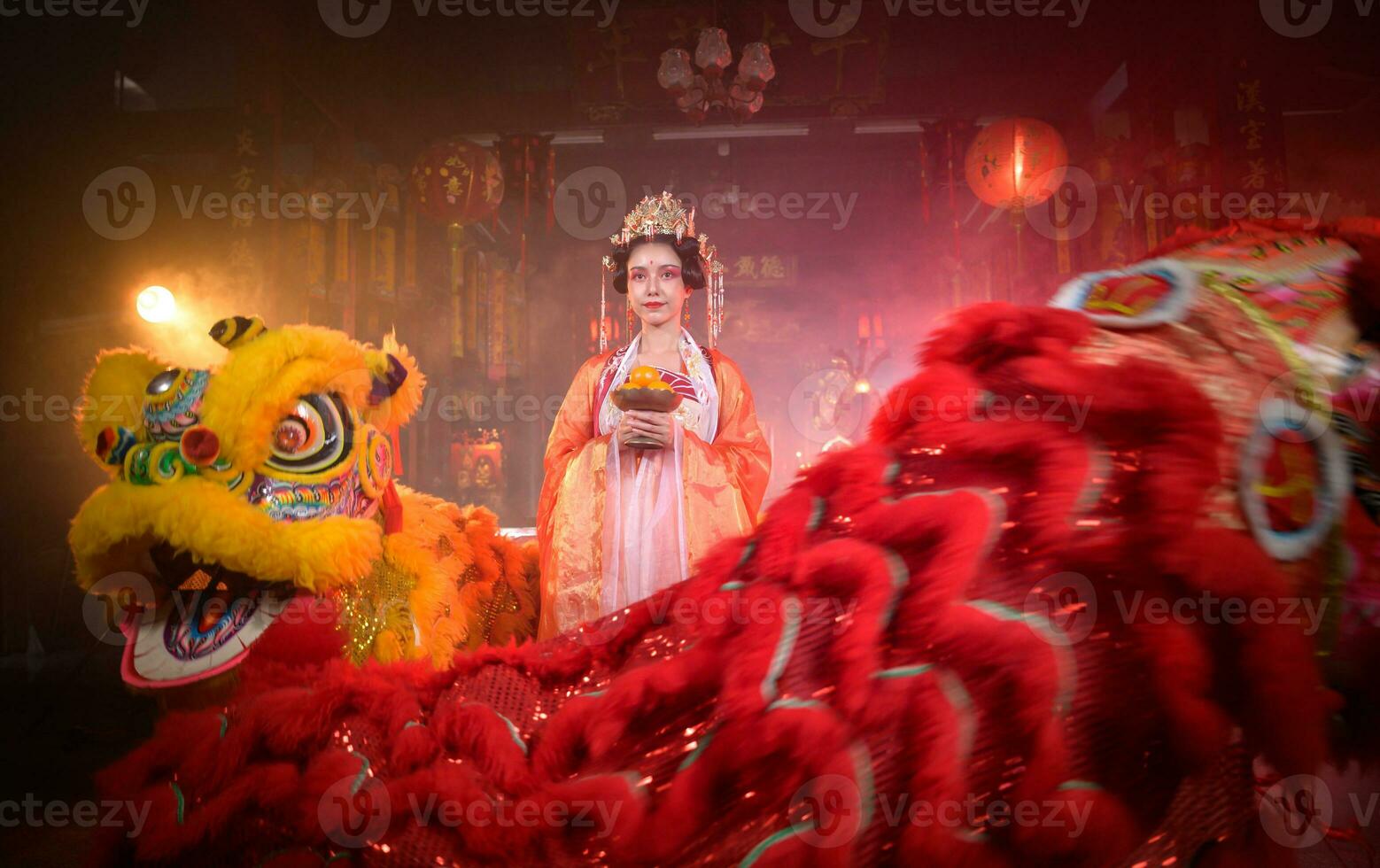 Chinese woman with yellow and red lions It is considered to enhance the prosperity for oneself on the occasion of the Chinese New Year festival every year photo