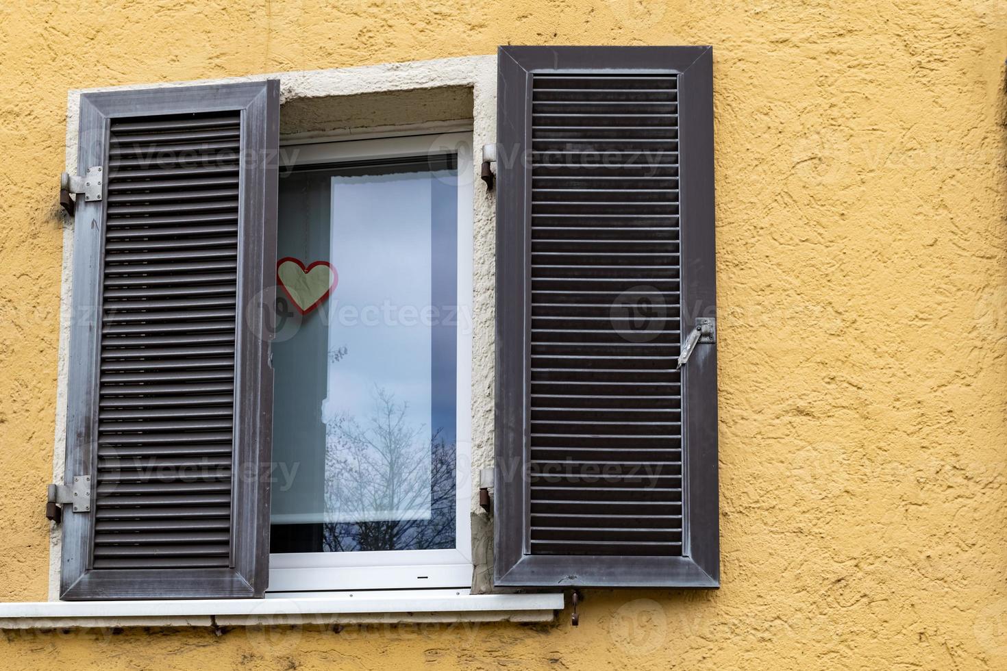 a window with dark brown shutters photo